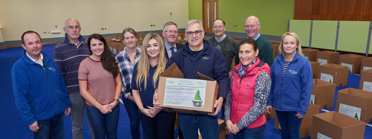 Simple Power Chief Executive Philip Rainey and Rural Support Cief Executive Jude McCann with producers and packers at the Hamper Scheme packing day 2017