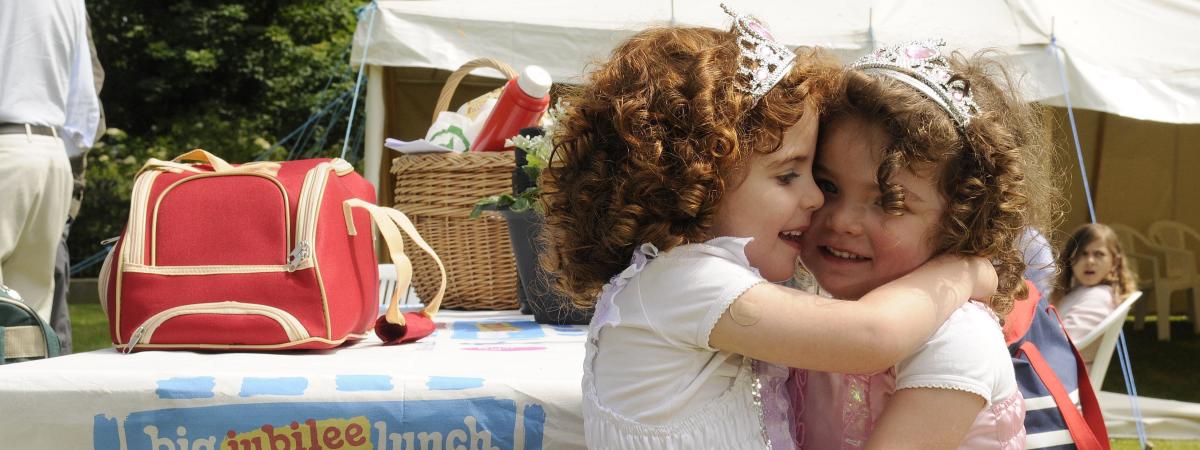 ​Jessica Kee enjoys her sister Sophie's company at The Big Jubilee Lunch during the Diamond Jubilee Celebration in Grey Point Fort, Helens Bay.