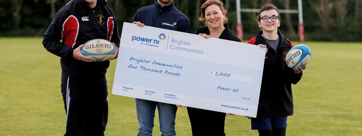 Pictured (L-R) is Newforge Taggers RFC captain Adam Smyth, Power NI representative Barry Rogan, Project Organiser Brenda Murphy and Under-15 player Rachel Bannon.