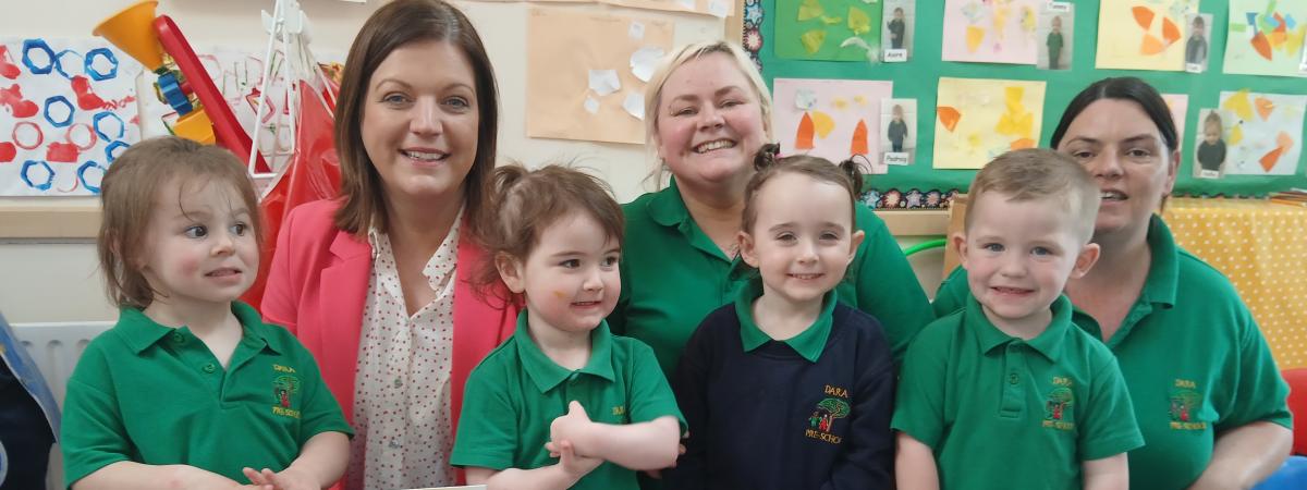 PHOTO CAPTION  Audrey Rainey, Chief Operating Officer, Early Years, is pictured with staff and children at Dara Pre-School in Armagh.