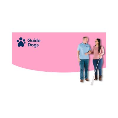 Banner showing the Guide Dogs pawprint logo with the text Guide Dogs and a man wearing a Guide Dogs poloshirt looking at and guiding a lady with a white long cane.