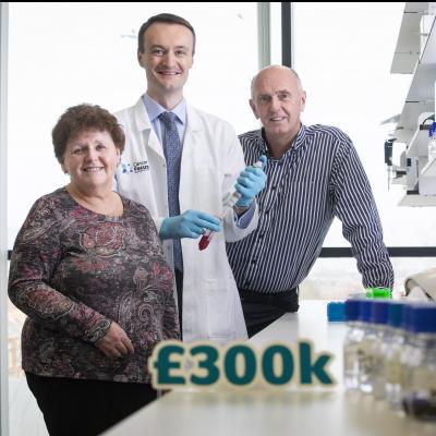 Cancer Focus NI chief executive announces £300k for research into pancreatic and oesophageal cancers with Dr Richard Turkington, leading the research, and cancer survivor Ivan McMinn
