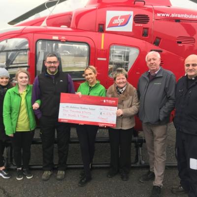 Air Ambulance NI Pilot Allan Bryers accepts a donation from Hillmount owners Robin and Edith Mercer and staff Courtney Best, Ashley Brown, David Proctor and Naomi Ferguson.