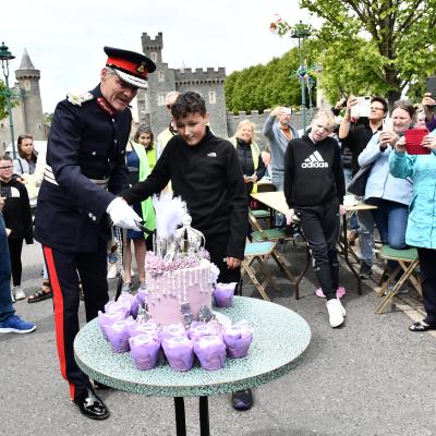 Lord Lieutenant Gawn Rowan Hamilton cuts the cake with the help of Tyson Chaddock at The Big Jubilee Lunch at Killyleagh on Sunday. An idea from Eden Project Communities, made possible by The National Lottery, The Big Jubilee Lunch is an official part of Her Majesty The Queen's special Platinum Jubilee celebration.